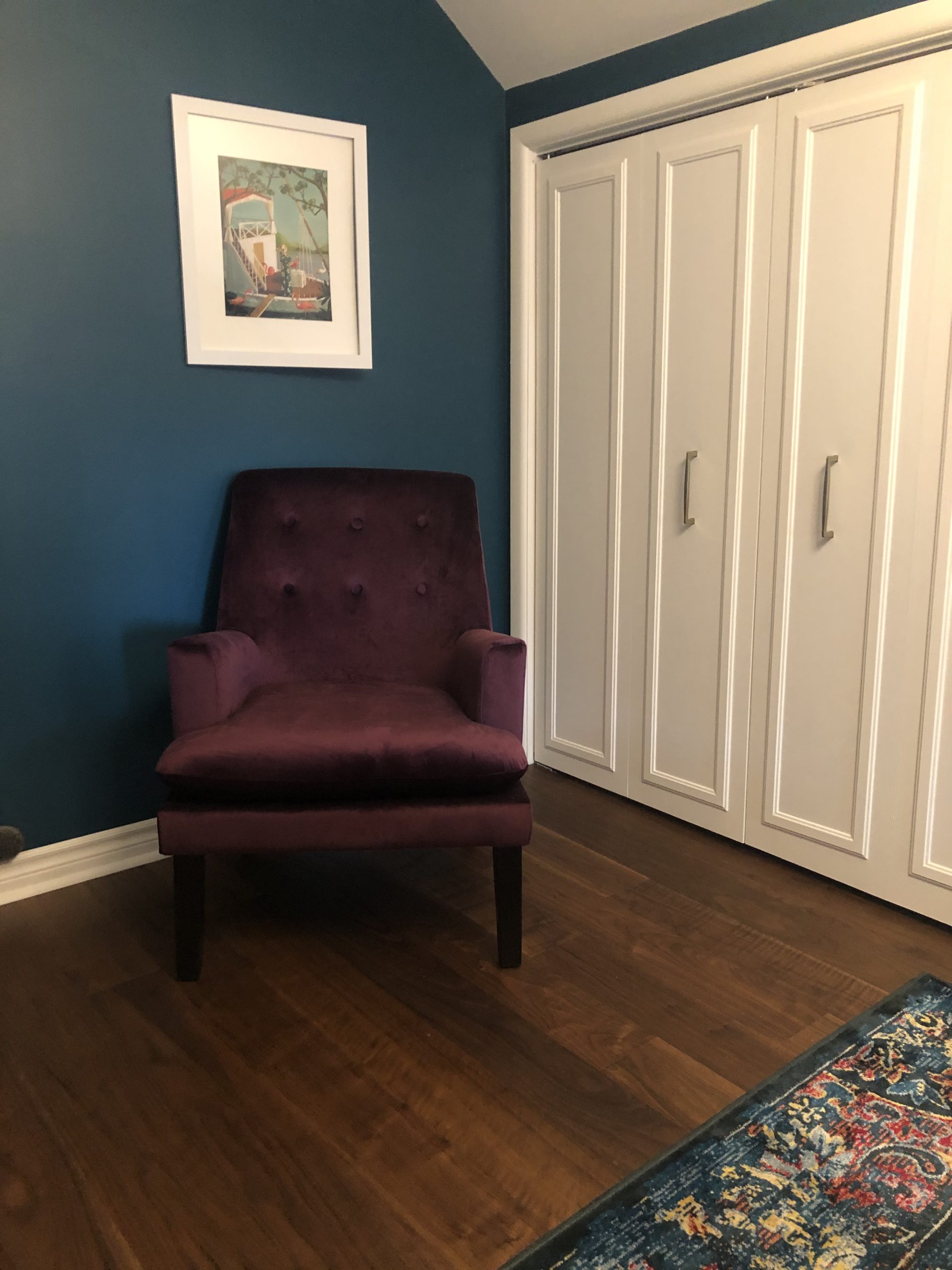 closed in closet with sitting chair and artwork